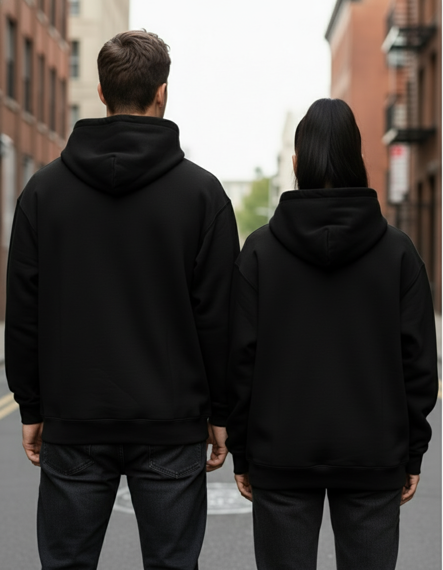 Back view of couple in black oversized hoodies